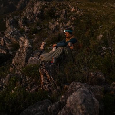 homme-assis-sac-de-couchage-lampe-frontale