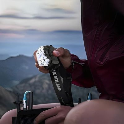 lampe-frontale-manteau-rouge-montagnes